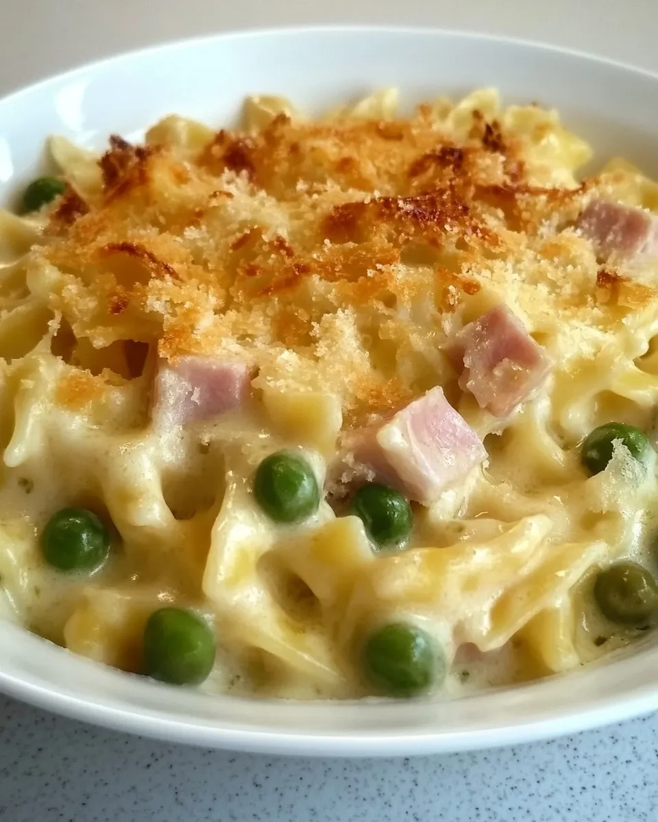 Tagliatelle besciamella, mozzarella, prosciutto e piselli